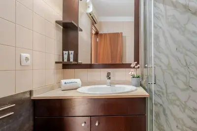 a bathroom with a sink and a mirror at HostWise - Stylish Flat with Balcony in Porto