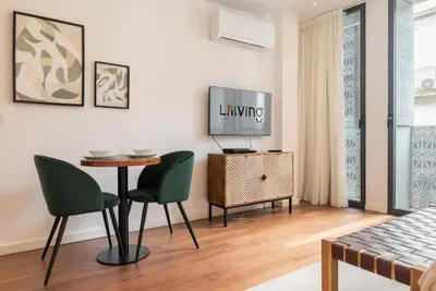 a living room with a television and a table and chairs at Liiiving in Porto - The Prestige Apartment A in Porto