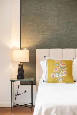 a bed with a yellow pillow and a lamp on a side table at Liiiving in Porto - The Prestige Apartment A in Porto