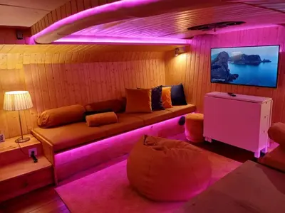 a living room with a couch with purple lights at SLEEPBOAT Golden Life in Porto