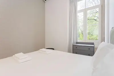 two white beds in a room with a window at Liiiving in Porto - Crystal Luxury Apartment in Porto