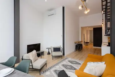 a living room with a yellow couch and chairs at Liiiving in Porto - Crystal Luxury Apartment in Porto