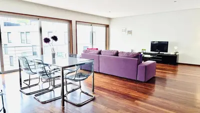 a living room with a purple couch and a glass table at VER Torrinha -Porto in Porto