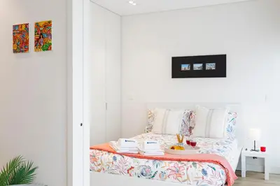 a bedroom with a bed with a tray of food on it at Studio w/ Terrace, Pool & Gym | Antas by Host Wise in Porto