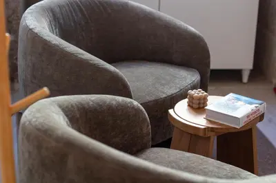 a chair and a table with a book on it at Cozy Mezzanine Hideaway w AC by LovelyStay in Porto