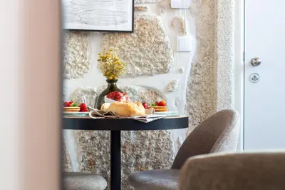 a table with fruit and a vase on it at Cozy Mezzanine Hideaway w AC by LovelyStay in Porto