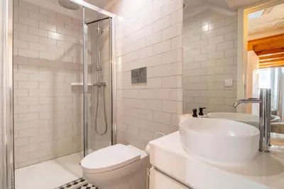 a bathroom with a sink and a toilet and a shower at Cozy Mezzanine Hideaway w AC by LovelyStay in Porto