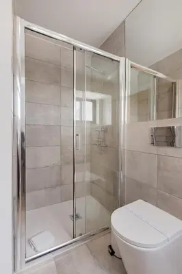 a bathroom with a white sink and a window at Saldanha Boho Duplex in Porto