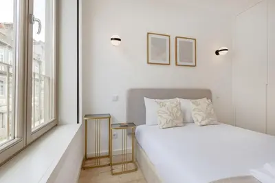 a dining room and living room with a table and chairs at The Prime Loft @ BoaVista Flats in Porto