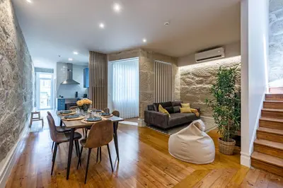a living room with a table and a couch at ApartmentsPorto - Porto Dukes House in Porto