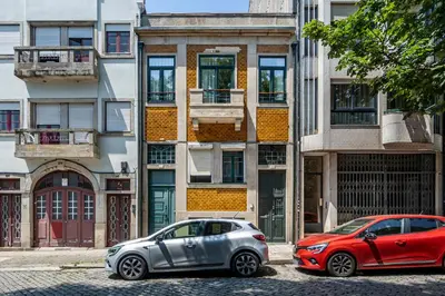 two cars parked in front of a building at ApartmentsPorto - Porto Dukes House in Porto