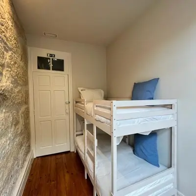 a room with two bunk beds and a door at ApartmentsPorto - Porto Dukes House in Porto