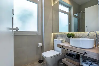 a bathroom with a sink and a toilet and a window at ApartmentsPorto - Porto Dukes House in Porto