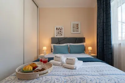 a bedroom with a bed with a tray of fruit on it at HostWise - Quinta do Vintém w/ Terrace near WOW in Vila Nova de Gaia