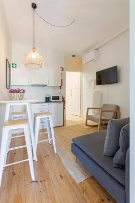 a kitchen and living room with a couch and a table at Viela Chic by Cozy Stay in Porto