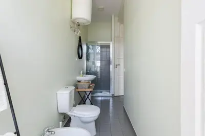 a bathroom with a toilet and a sink at Viela Chic by Cozy Stay in Porto
