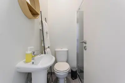 a white bathroom with a toilet and a sink at Viela Chic by Cozy Stay in Porto