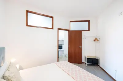 a kitchen with white cabinets and a washing machine at VIVA Cozy Nest Studio Porto in Porto