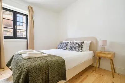 a white bedroom with a bed and a window at Art Deco 11 Luxury 2BR Apartment Downtown Metro AC in Porto