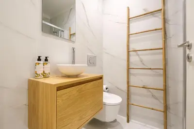 a bathroom with a sink and a toilet at Art Deco 11 Luxury 2BR Apartment Downtown Metro AC in Porto