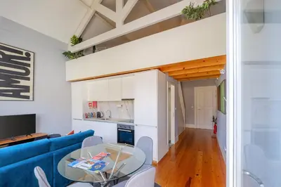 a living room with a blue couch and a table at Bonfim Garden Apartment Near Metro & City Center in Porto