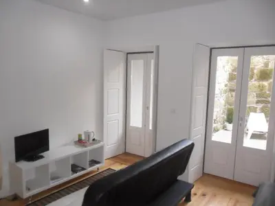 a living room with a couch and a television at Your Place Porto II in Porto