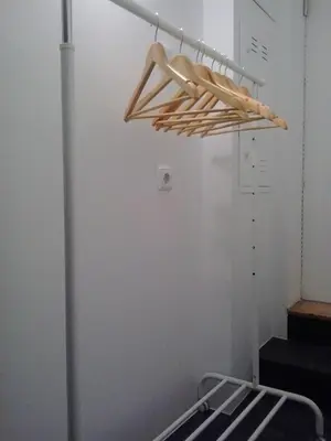 a rack with wooden hangers in a room at Your Place Porto II in Porto