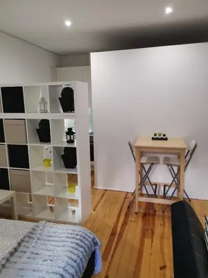 a bedroom with a bed and a desk and a table at Your Place Porto II in Porto