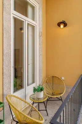 two chairs and a table on a porch at New!! Oporto D Joao IV in Porto