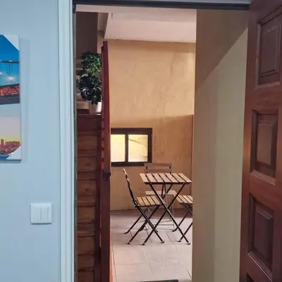 a door leading into a room with a table and chairs at Miragaia Charm Apartment in Porto