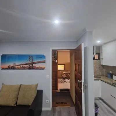 a living room with a bridge painting on the wall at Miragaia Charm Apartment in Porto