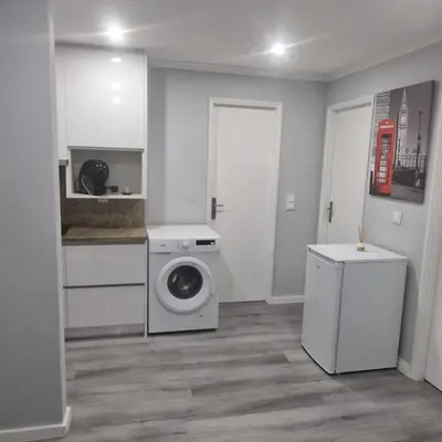 a laundry room with a washing machine in it at Miragaia Charm Apartment in Porto