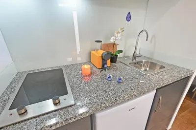 a kitchen with a sink and a counter top at Casa do Palácio 16 e 17 in Porto