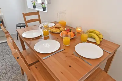 a wooden table with plates of food and glasses of orange juice at Crystal Palace House - T2 - D13 in Porto