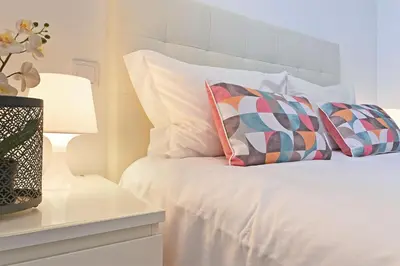 a white bed with two pillows on top of it at Crystal Palace House - T2 - D13 in Porto