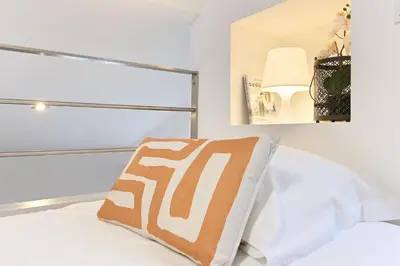 a bedroom with a bed with a pillow and a lamp at Crystal Palace House - T2 - D13 in Porto
