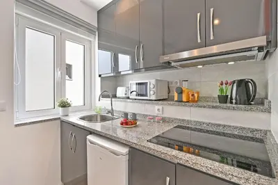 a kitchen with a sink and a counter top at Crystal Palace House - T2 - D13 in Porto