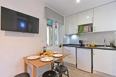 a kitchen with a table with two chairs and a tv at Crystal Palace House - D19 in Porto