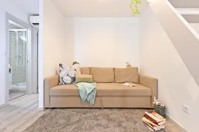 a living room with a couch with pillows on it at Crystal Palace House - D19 in Porto
