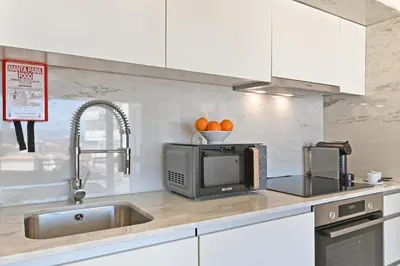 a kitchen with a sink and a microwave at Vera Cruz Porto Apartment in Porto
