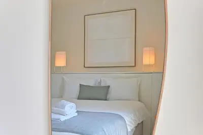 a bedroom with a bed with two towels on it at Vera Cruz Porto Apartment in Porto