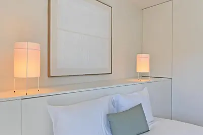 a bedroom with two lamps and a bed with a mirror at Vera Cruz Porto Apartment in Porto
