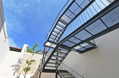 a metal stairway leading up to a building at Vera Cruz Porto Apartment in Porto