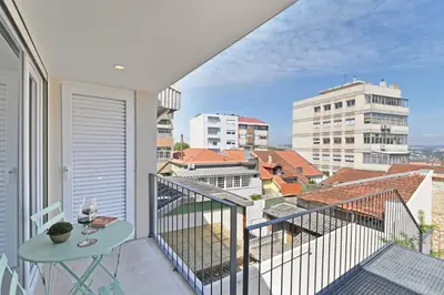 a balcony with a table and a view of the city at Vera Cruz Porto Apartment in Porto