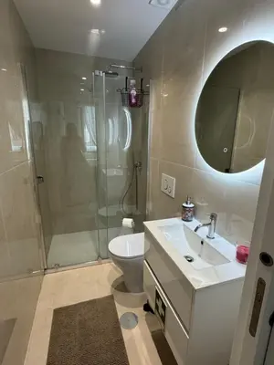 a bathroom with a shower and a sink and a toilet at Porto Suites in Porto