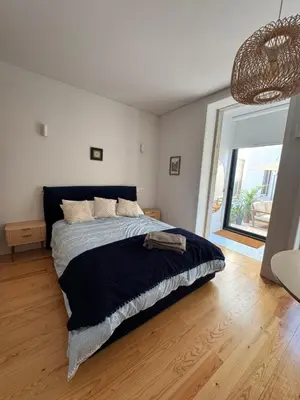 a bedroom with a bed and a large window at Porto Suites in Porto