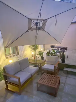 a living room with a couch and a large umbrella at Porto Suites in Porto