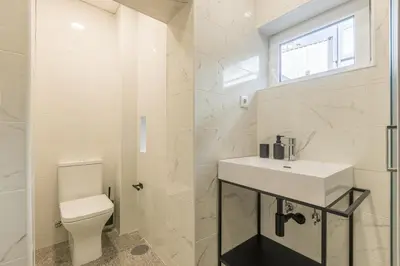 a white bathroom with a sink and a toilet at Albertina Carlos Alberto by Aspasios in Porto