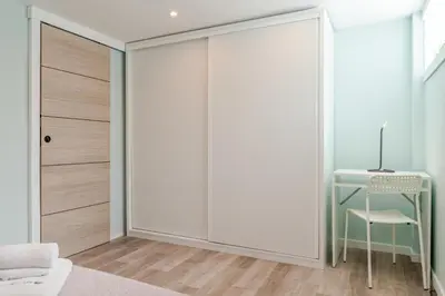 a room with a sliding closet door with a desk at Quinta do Vintém near WOW by HostWise in Vila Nova de Gaia