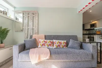 a living room with a gray couch with pillows at Quinta do Vintém near WOW by HostWise in Vila Nova de Gaia